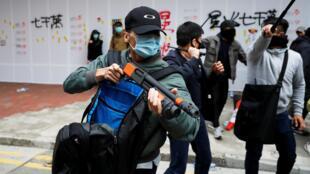 A heavily-armed plain-clothes police officer helping to disperse anti-government protesters in Hong Kong.