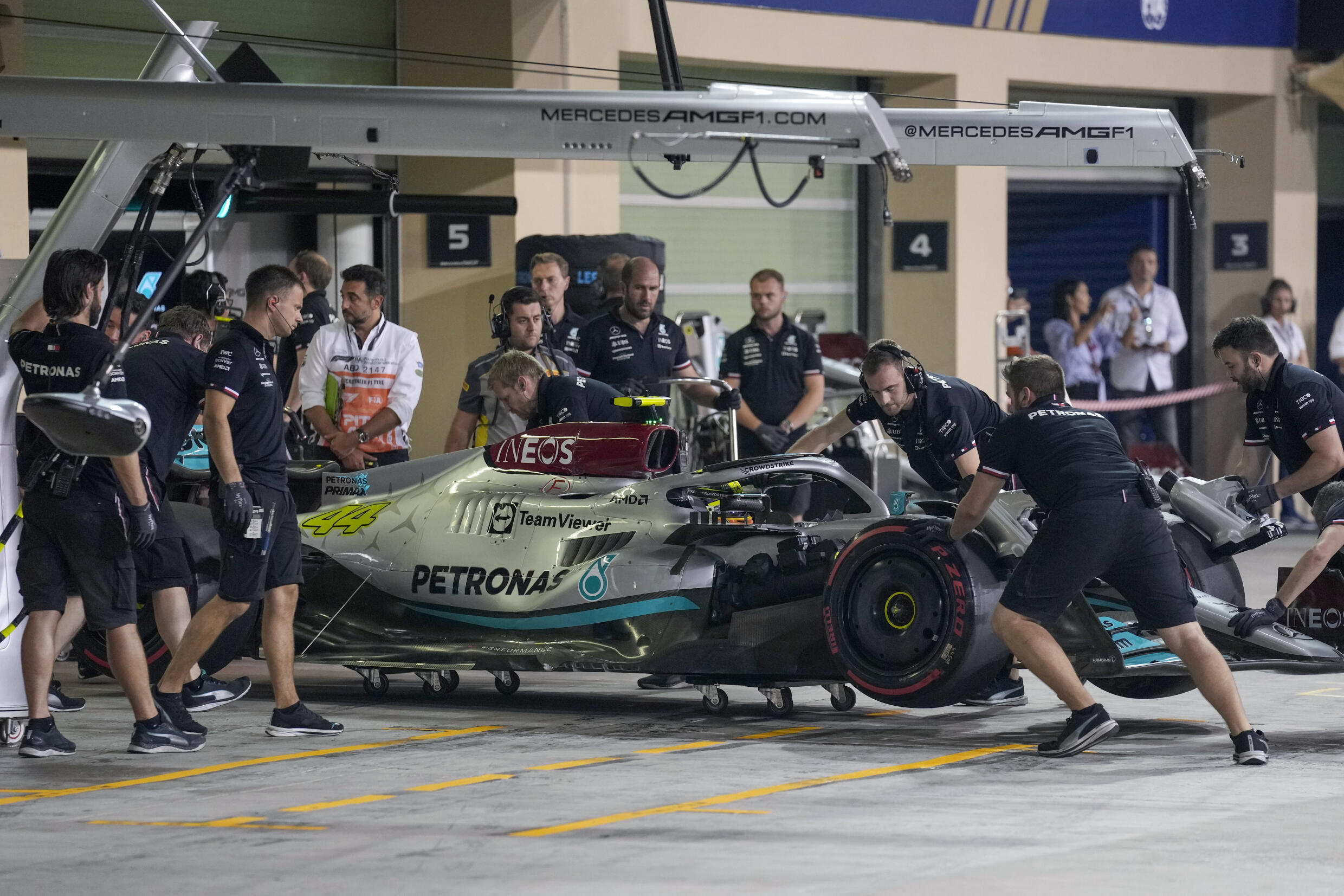 Mecánicos empujan el coche del piloto de Mercedes Lewis Hamilton hacia el garaje durante la sesión de clasificación en la víspera del Gran Premio de Abu Dabi de Fórmula Uno, el 19 de noviembre de 2022