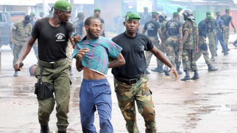 A protester is arrested at Conakry’s main stadium on 28 September 2009, when security forces crushed an opposition rally. A UN inquiry later found at least 156 people were killed and more than 100 women raped.