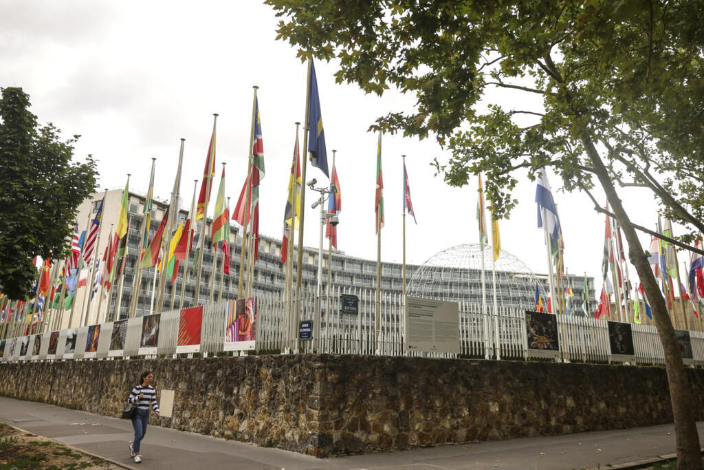 A woman walks by the UNESCO headquarters Tuesday, July 22, 2025 in Paris.  (Photo AP25203380094907 /Thomas Padilla)