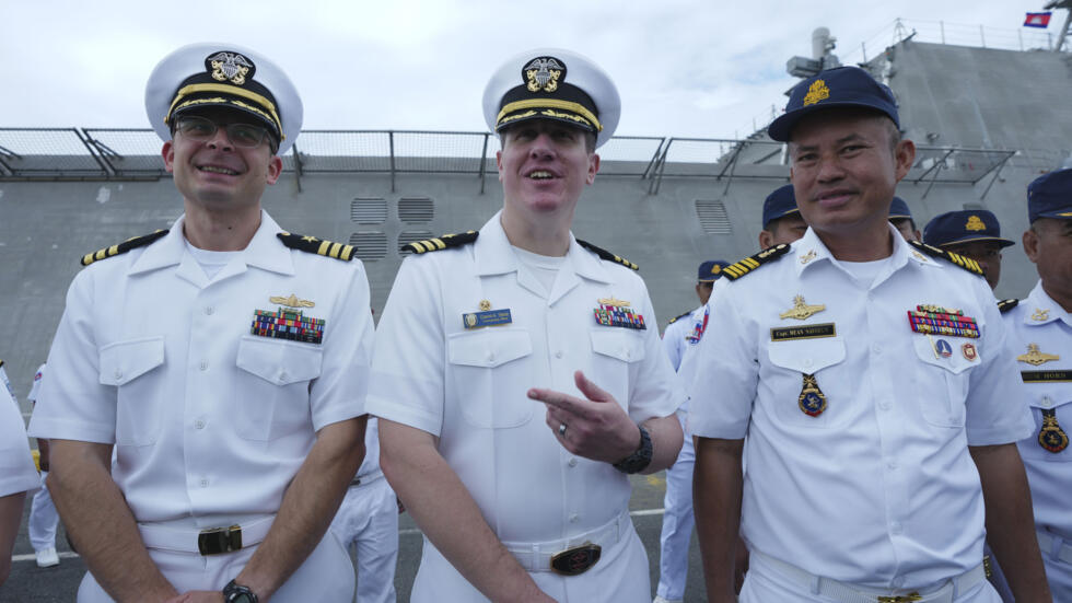 Daniel A. Sledz, center, commanding officer of USS Savannah, meets with Cambodian Deputy Commander of Ream Naval Base, Capt. Mean Savoeun, right, as it arrives for a port call at Sihanoukville port, C