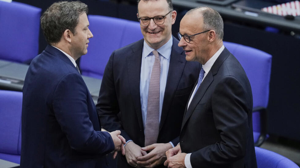 Friedrich Merz, right, CDU faction leader Jens Spahn, centre and SPD leader Lars Klingbeil stand together n the parliament Bundestag in Berlin, Tuesday, May 6, 2025.