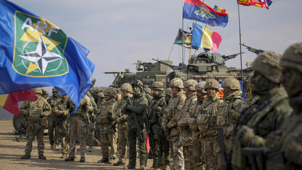 Servicemen stand at the end of the Steadfast Dart 2025 exercise, involving some 10,000 troops in three different countries from nine nations and represent the largest NATO operation planned this year,