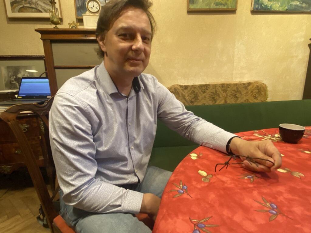Nicolas Zikov dans son appartement à Saint-Pétersbourg. Il tient dans sa main un reste de barbelé du goulag où a été détenu son arrière-grand-père.