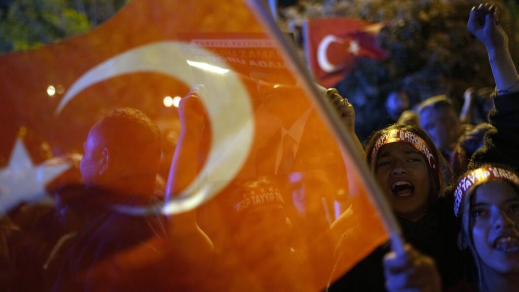Supporters of President Recep Tayyip Erdogan shout slogans outside the headquarters of AK Party in Istanbul. The first presidential poll proved inconclusive and a run-off will be held on 28 May.