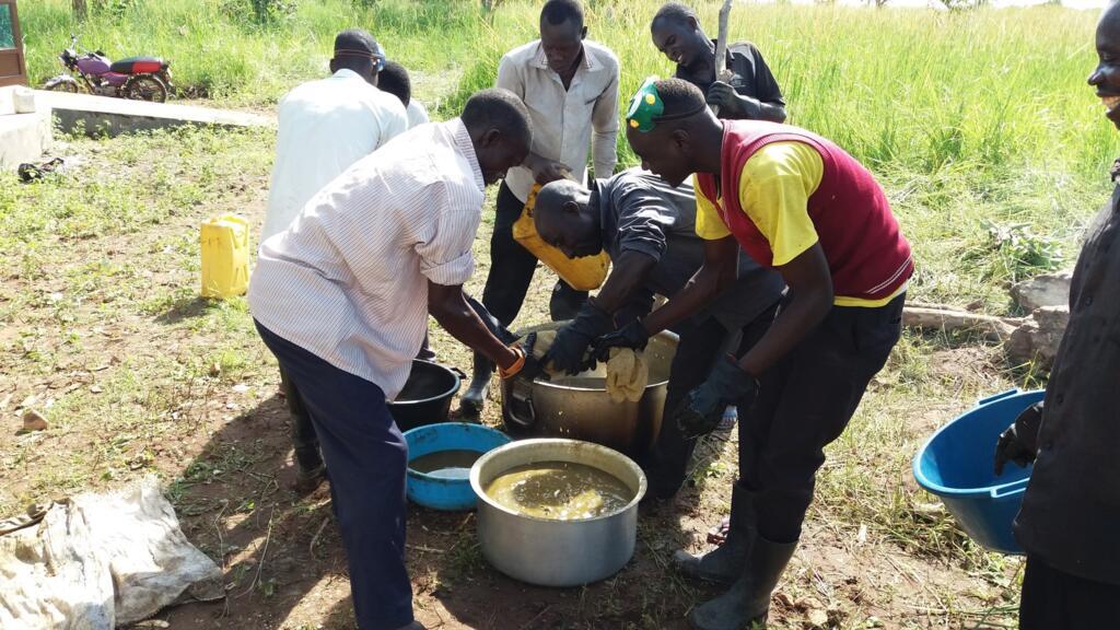 Farmers near the northern boundary of Uganda’s Murchison Falls National Park prepare repellent from dung, eggs, garlic and other natural ingredients.