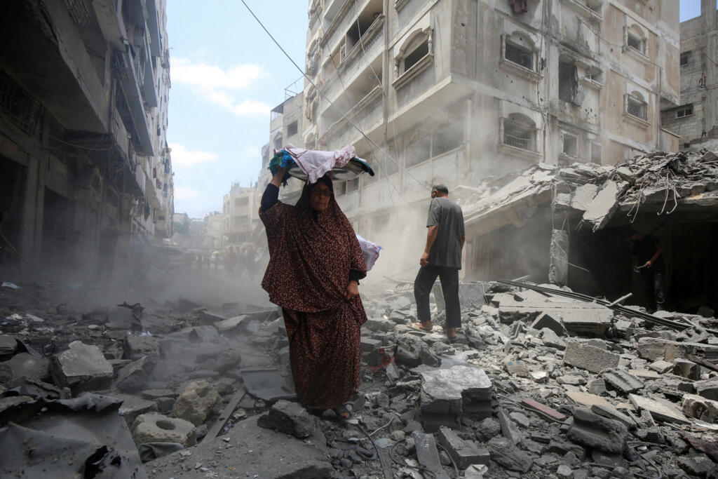 Palestinos inspecionam os escombros de uma casa na cidade de Gaza, em 8 de agosto de 2025.