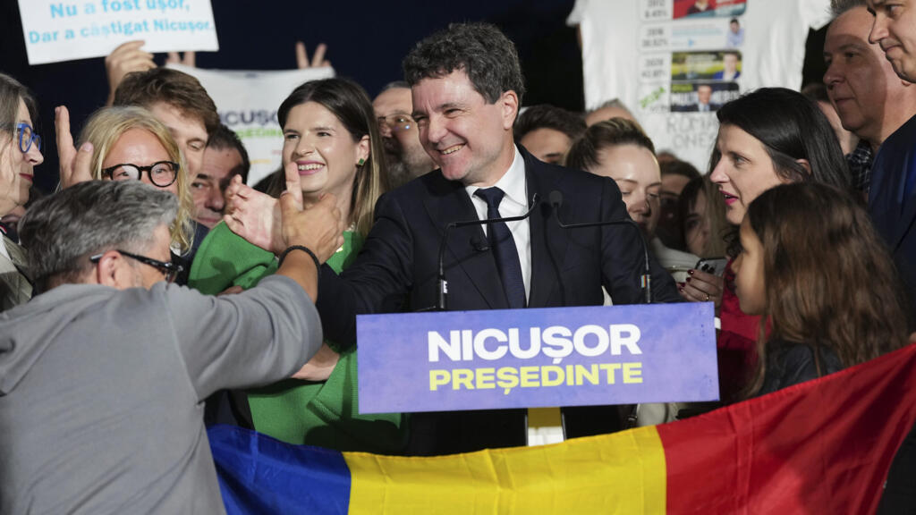 Presidential candidate Nicusor Dan speaks to media after polls closed for the second round of the country's presidential election redo in Bucharest, Romania, Sunday, May 18, 2025.