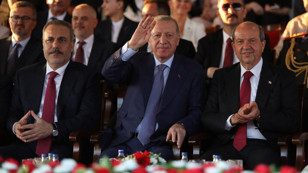 Turkish Foreign Minister Hakan Fidan, Turkish President Recep Tayyip Erdogan and Turkish Cypriot leader Ersin Tatar attend a military parade commemorating Turkey's 1974 invasion of Cyprus in Nicosia on 20 July 2025.