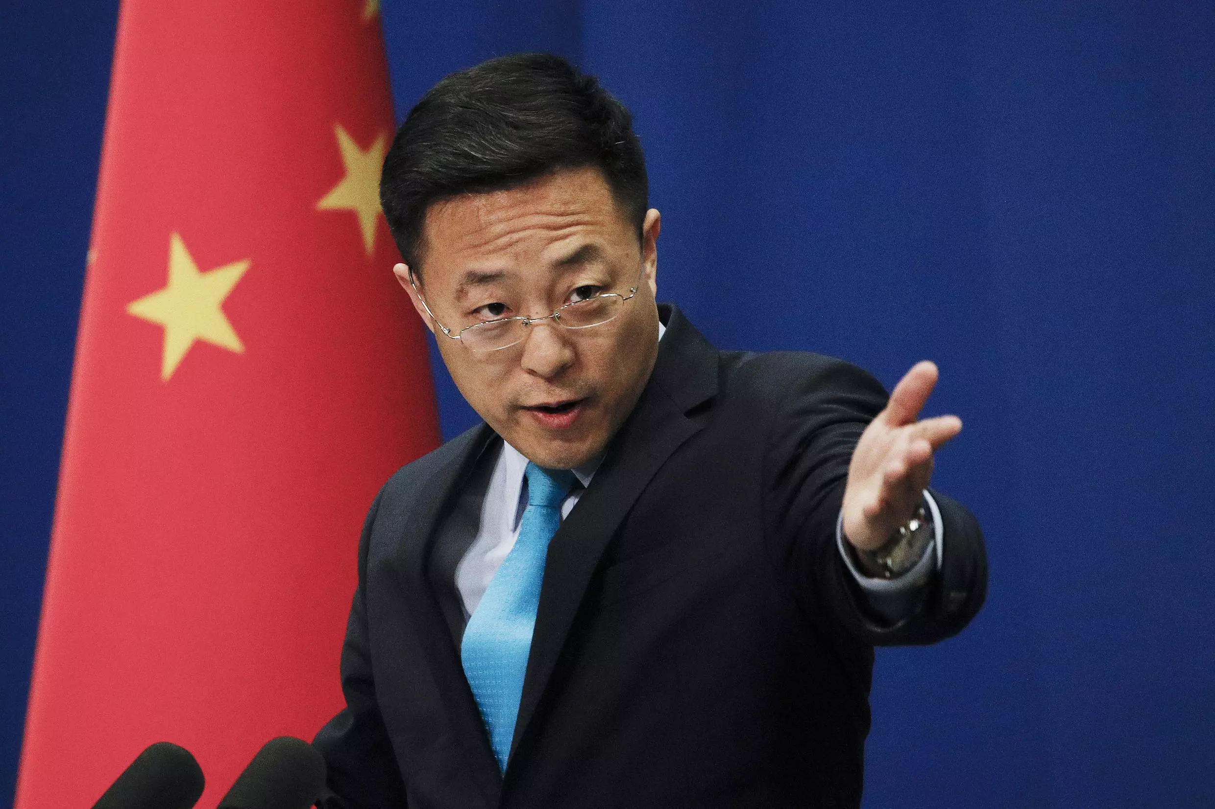 In this file photo taken Monday, Feb. 24, 2020, Chinese Foreign Ministry new spokesman Zhao Lijian gestures as he speaks during a daily briefing at the Ministry of Foreign Affairs office in Beijing.