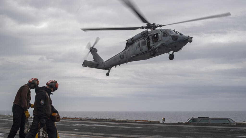 In this handout photo provided by the U.S. Navy, MH-60S Sea Hawk, assigned to the "Eightballers" of Helicopter Sea Combat Squadron (HSC) 8, lands on the flight deck of the Nimitz-class aircraft carrie