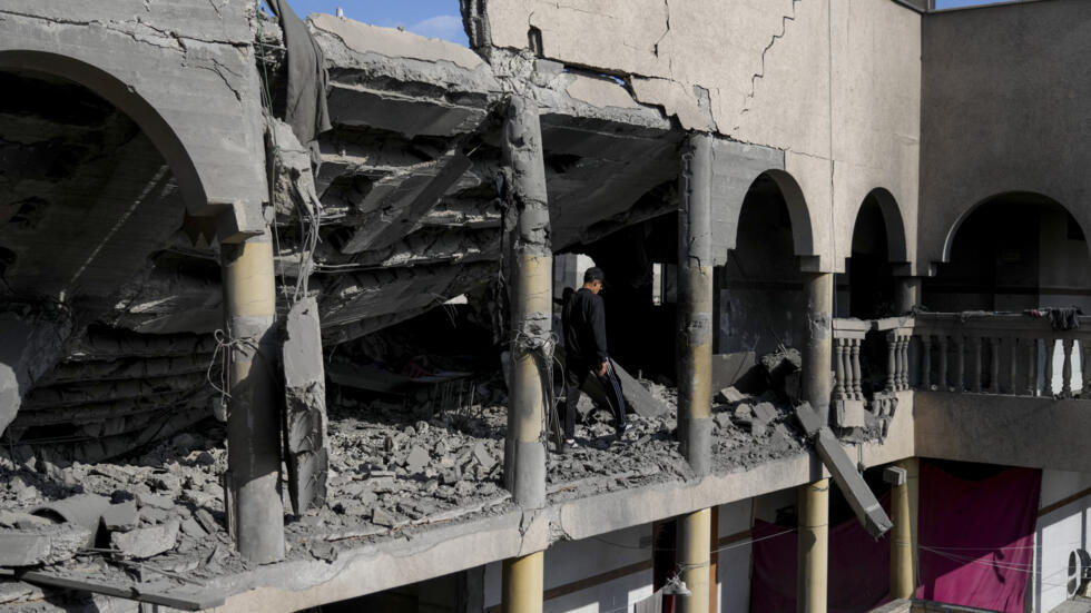 Palestinians inspect the damage at Al-Tabi'in School in central Gaza Strip following an Israeli airstrike, Tuesday, March 18, 2025.