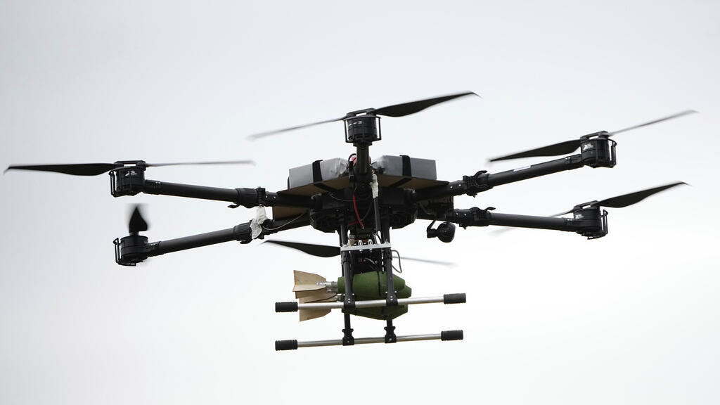 A drone carrying a bomb flies over during joint Russian-Belarusian military drills at a training ground near Barysaw, Belarus, Monday, Sept. 15, 2025. (AP Photo/Pavel Bednyakov)