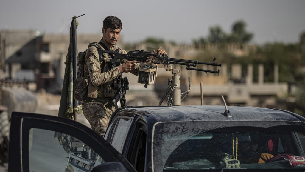 A fighter with the US-backed Syrian Democratic Forces in an armoured vehicle at al-Sabha, in the eastern countryside of Deir el-Zour, Syria.