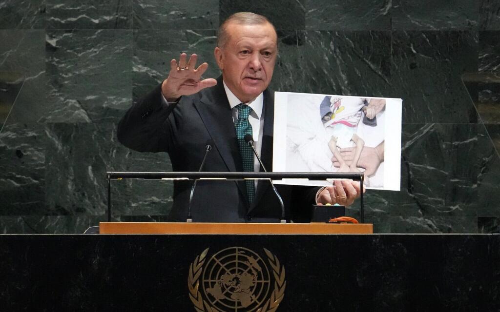 Turkish President Recep Tayyip Erdogan displays a photo from Gaza while addressing the UN General Assembly in New York on 23 September 2025.