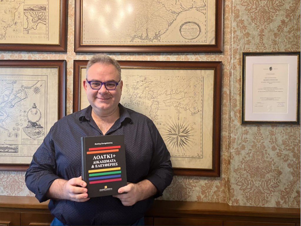 L'avocat Vasilis Sotiropoulos pose dans son cabinet avec son nouveau livre « LGBTQI + Droits et libertés »
