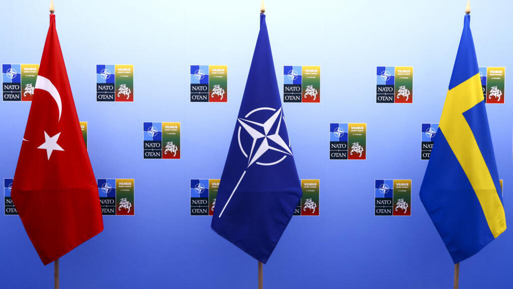From left, the flags of Turkey, NATO and Sweden stand together at a NATO summit in Vilnius, Lithuania, on July 10, 2023.