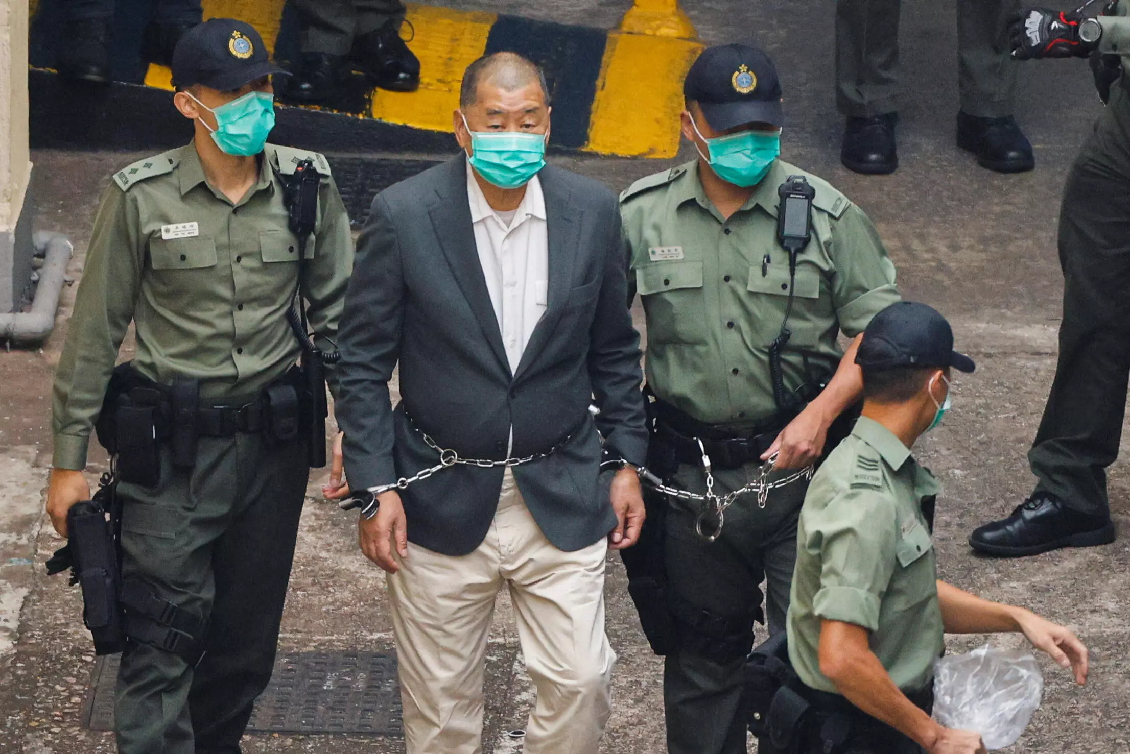 Media mogul Jimmy Lai Chee-ying, founder of Apple Daily, walks to a prison van to head to court, after being charged under the national security law, in Hong Kong, China December 12, 2020. REUTERS/Tyrone Siu
