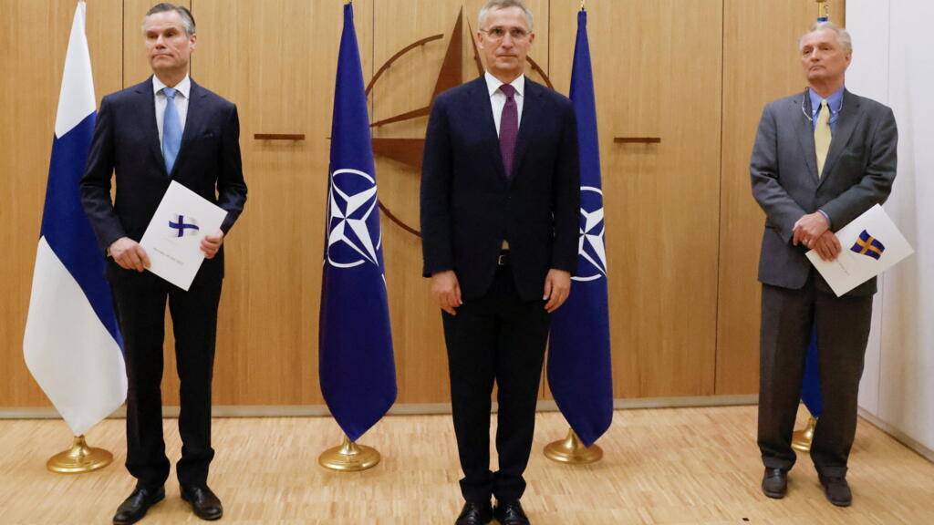 Finland's Ambassador to NATO Klaus Korhonen, NATO Secretary-General Jens Stoltenberg and Sweden's Ambassador to NATO Axel Wernhoff attend a ceremony to mark Sweden's and Finland's application for membership in Brussels, Belgium, May 18, 2022.