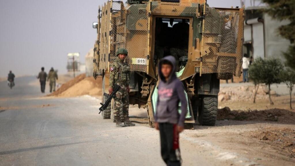 A Turkish soldier stands near his armoured vehicle on a highway near the northern Syrian town of Ain Issa in the countryside of the Raqqa region, on November 26, 2019.