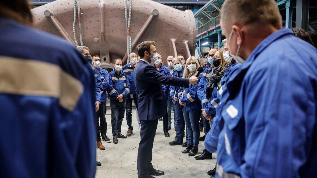 French President Emmanuel Macron talks to workers at GE's main production site for its nuclear turbine systems in Belfort, eastern France, on 10 February 2022, as part of a visit dedicated to energy policy and the future of the country's atomic industry.