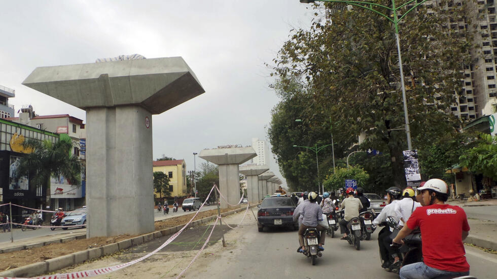 Motorists pass by a stretch of an under construction metro railway project in Hanoi, Vietnam, Sunday, April 7,  2013. (AP Photo/Nick Ut)