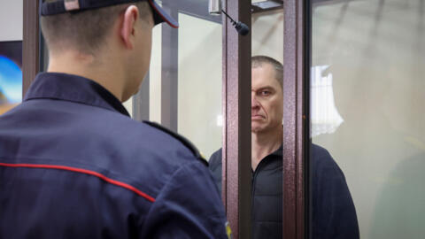 Journalist Andrzej Poczobut stands in a defendants' cage during a court session in Grodno, Belarus on 16 January 2023.