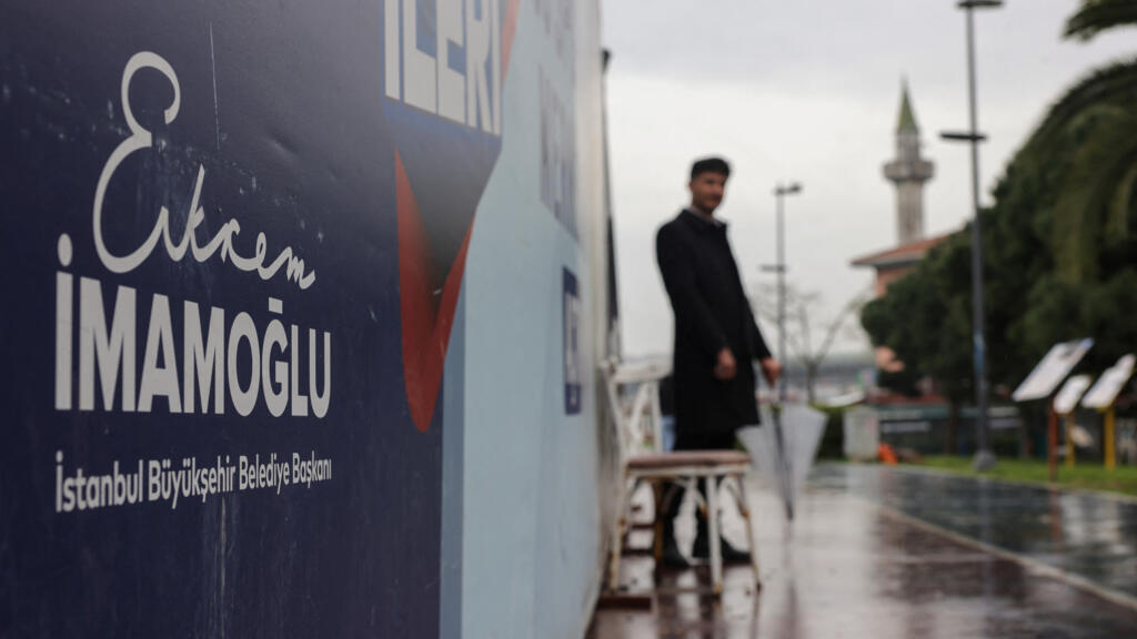 A man stands near posters featuring the name of the jailed Istanbul Mayor Ekrem Imamoglu, on the third day of the Eid al-Fitr holiday in Istanbul,Turkey April 1, 2025.