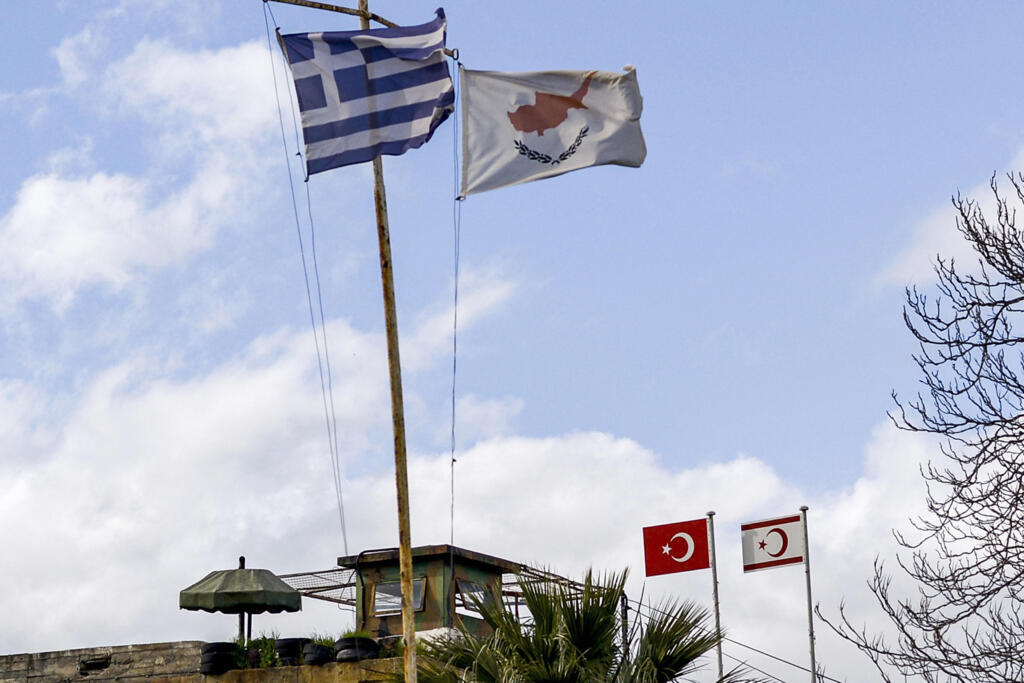 The flags of Greece, Cyprus, Turkey and the self-proclaimed Turkish Republic of Northern Cyprus fly above security outposts in the divided Cypriot capital Nicosia.