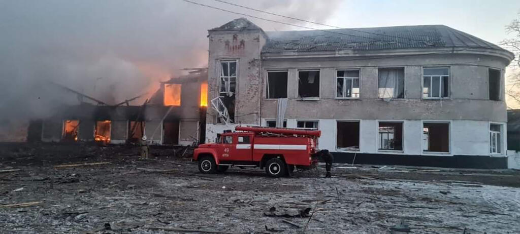 Dans cette photo prise et publiée par le Service national d'urgence d'Ukraine le 17 mars 2022, des pompiers travaillent pour éteindre un incendie dans un établissement d'enseignement touché par des bombardements dans la ville de Merefa dans la région de Kharkiv.