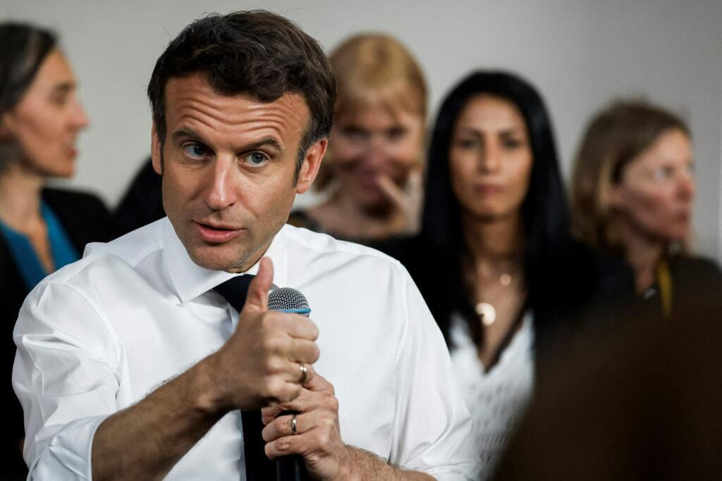 French incumbent president and candidate of La Republique en Marche (LREM) party for the presidential election Emmanuel Macron meets representatives of associations working in the "Fontaine d'Ouche" neighborhood in Dijon, on March 28, 2022.