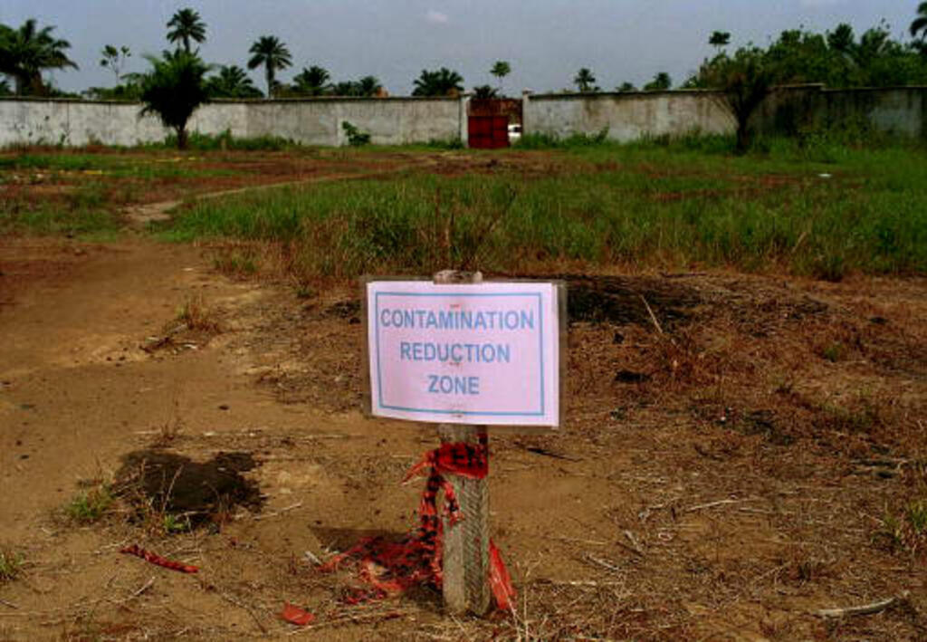 A sign standing in the area of a 30-year-old uncleaned major oil spill in the Ogoniland area of Nigeria, photographed in March 2001, in Ebubu, Nigeria.