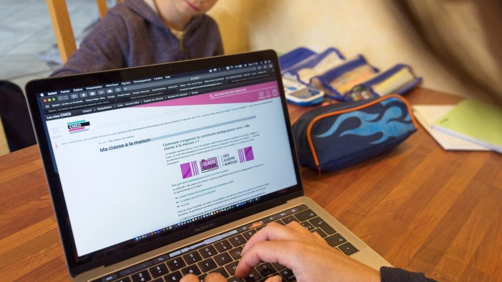 Une mère utilise l'application «Ma classe à la maison» mise à disposition par le CNED pour l'école à domicile de son fils, le 21 mars 2020 à Montlouis-sur-Loire, dans le centre de la France.