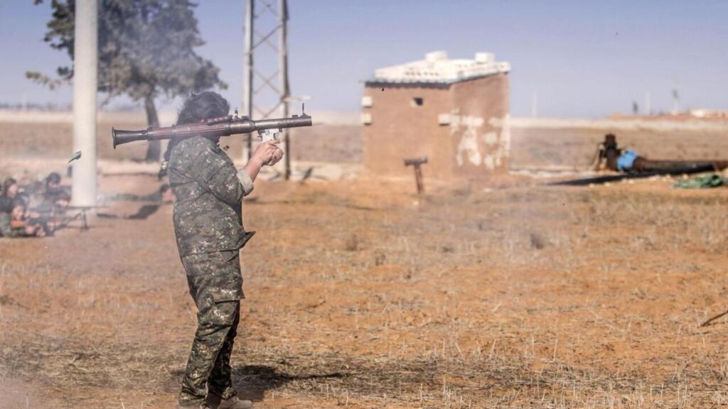 A female fighter of the Kurdish People's Protection Units (YPG) fires a rocket-propelled grenade (RPG) during military training in the western countryside of Ras al-Ain January 25, 2015.