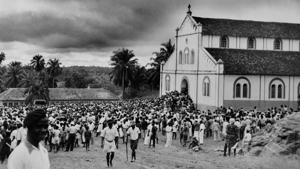 Des personnes s'apprêtent à entrer dans une église pour assister à la messe, à Yaoundé, Cameroun, septembre 1948.
