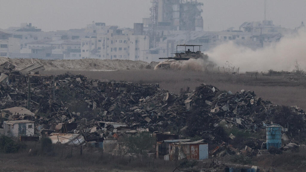 An Israeli tank maneuvers near Gaza city, as seen from Israeli side of the border, August 16, 2025.