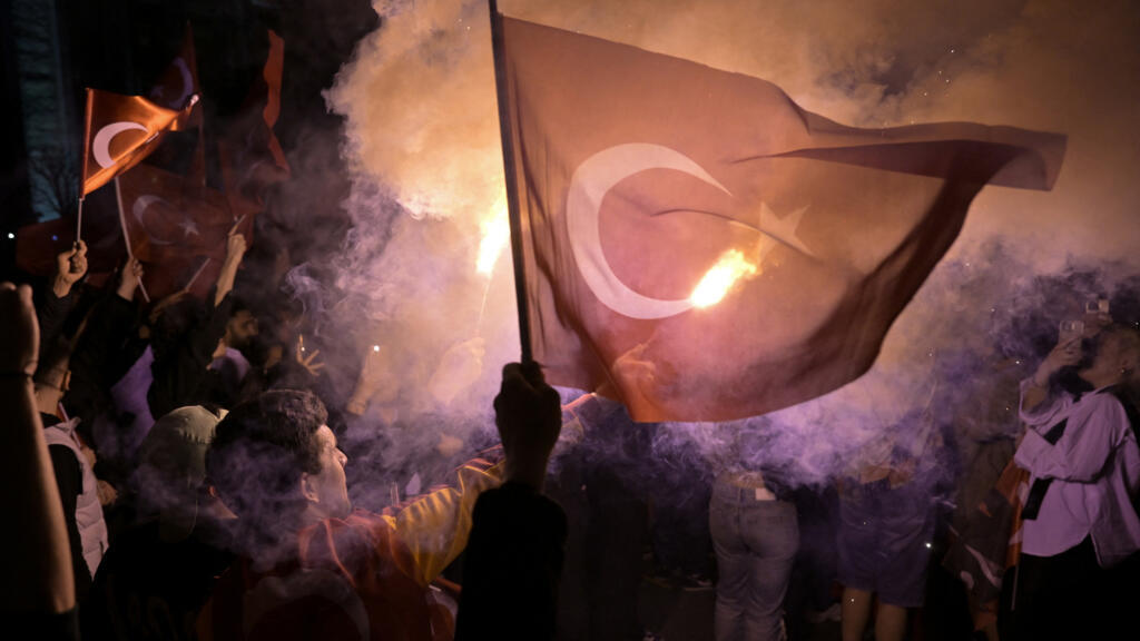 Opposition Republican People's Party (CHP) supporters celebrate outside the main municipality building following municipal elections across Turkey, in Istanbul on March 31, 2024. 