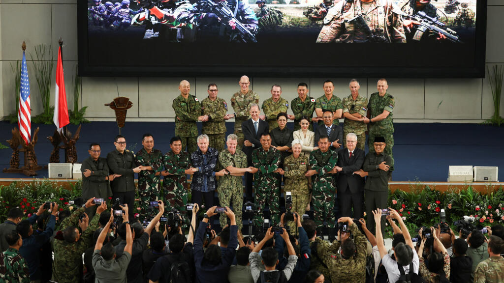 Indonesian Deputy Military Chief Gen. Tandyo Budi Revita and Navy Adm. Samuel Paparo, the U.S. Indo-Pacific Commander, along with other nations' military personnel and officials, take a group photo during the opening ceremony of Super Garuda Shield, an annual joint military exercise involving Indonesia, the U.S., Australia, Japan, Britain and several other nations, in Jakarta, Indonesia, August 25, 2025. REUTERS/Willy Kurniawan