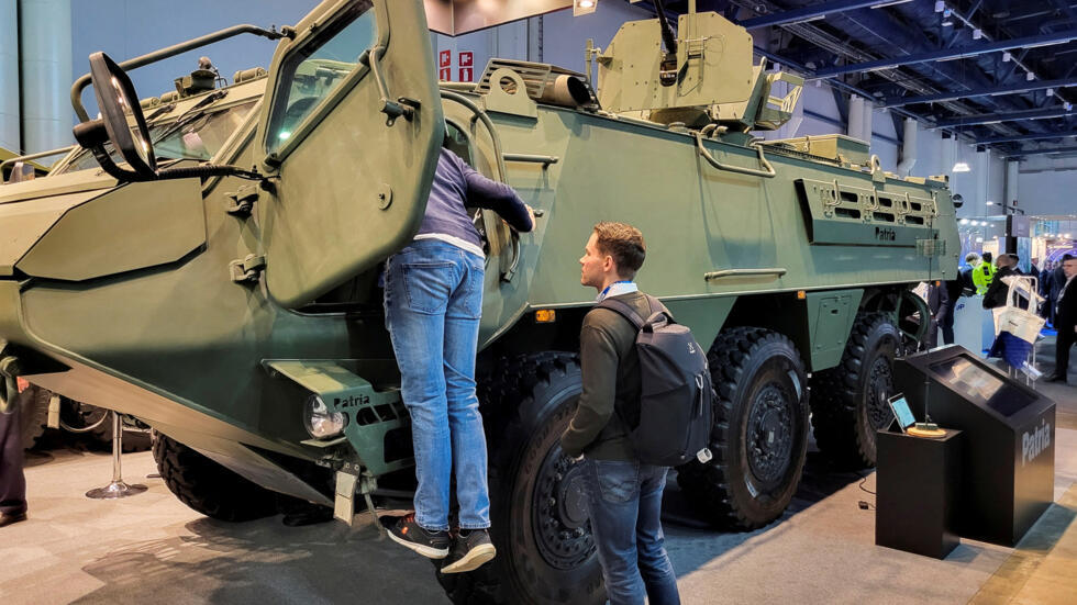 People look at the Finnish defence group Patria’s 6x6 Common Armoured Vehicle displayed at the SecD-Day 2025 security conference in Helsinki, Finland January 29, 2025.