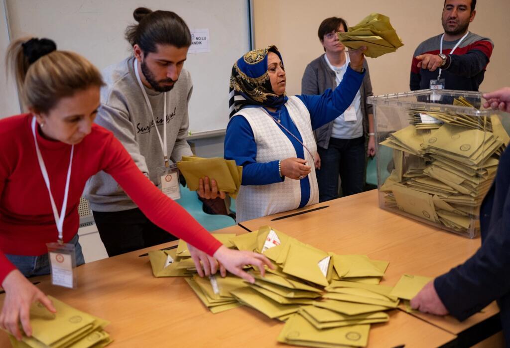 Election officials count ballots at a polling station in Istanbul on May 14, 2023, after polls closed in Turkey's presidental and parliamentary elections.