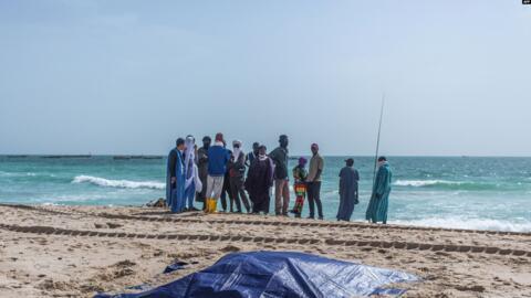 The bodies of migrants who perished in a shipwreck off the coast of Mauritania lie covered on a beach near Nouakchott on 24 July, 2024.