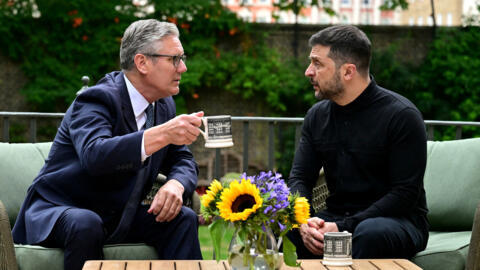 Britain's Prime Minister Keir Starmer talks with Ukraine's President Volodymyr Zelensky in the garden of 10 Downing Street in central London, Britain 14 August 2025.