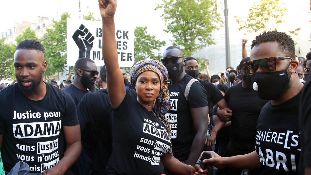 Assa Traore, sister of Adama Traore, raises her fist during a demonstration in Paris. Churning U.S. protests over George Floyd's death have revived anger in France over police violence, systemic racism and the complicated case of Adama Traore, a black Frenchman who died in police custody in 2016. For Traore's family, the Floyd protests have also revived their hopes for change.