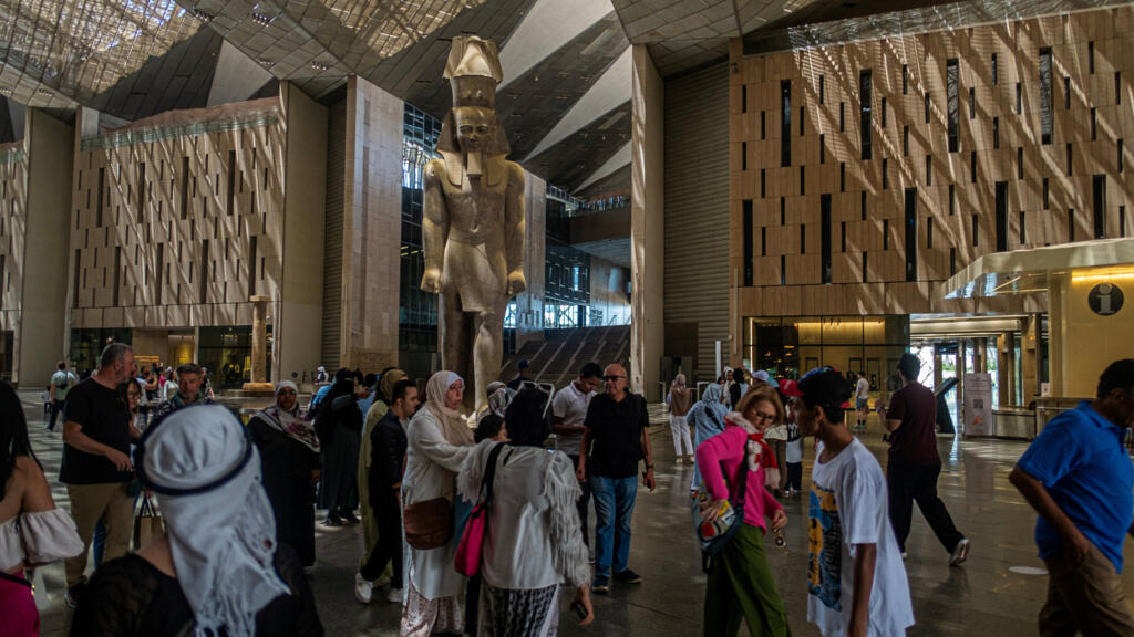 Des visiteurs visitent le Grand Musée égyptien à Gizeh, dans la banlieue sud-ouest de la capitale Le Caire, le 5 mai 2025. C'est en grande pompe que Le Caire inaugurera le 1er novembre le très attendu Grand Musée égyptien, largement présenté comme le couronnement des efforts déployés par les autorités pour réformer l'industrie touristique, vitale pour le pays.