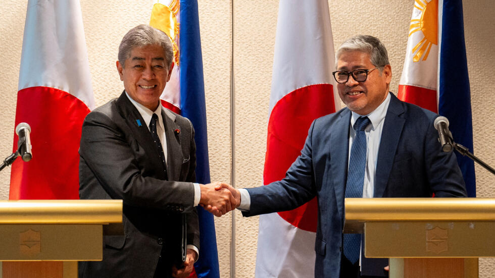 Japan Foreign Minister Takeshi Iwaya and Philippine Foreign Minister Enrique Manalo shake hands after a joint press conference, in Taguig City, Metro Manila, Philippines, January 15, 2025.