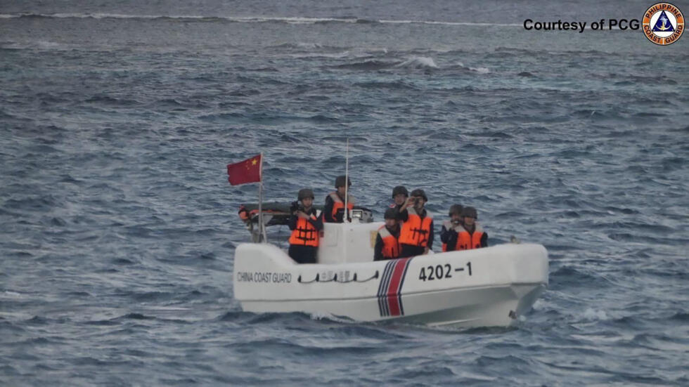 In this image released by Philippine Coast Guard, a Chinese Coast Guard boat sails around Sandy Cay in the South China Sea Friday, Jan. 24, 2025
