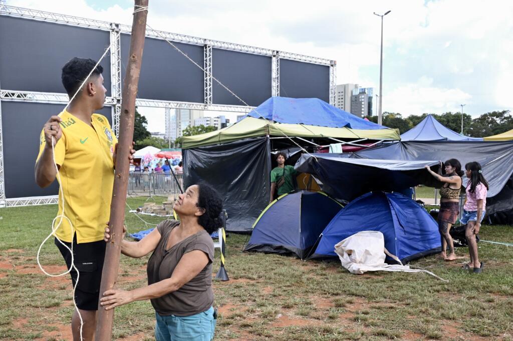 Indígenas da etnia Mundukuru montam uma barraca no Acampamento Terra Livre (ATL), em Brasília, em 6 de abril de 2025. A maior mobilização indígena do Brasil começa em 7 de abril e debaterá conflitos territoriais, clima e resistência.