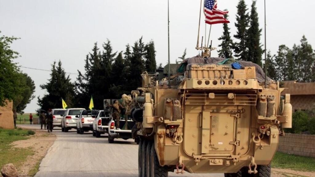 US forces, accompanied by Kurdish People's Protection Units (YPG) fighters, drive their armoured vehicles near the northern Syrian village of Darbasiyah, on the border with Turkey in 2017.