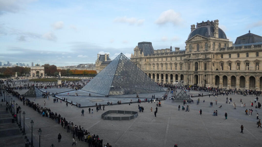 Des gens font la queue devant le musée du Louvre, trois jours après le vol de bijoux historiques lors d'un braquage audacieux en plein jour, le mercredi 22 octobre 2025 à Paris.