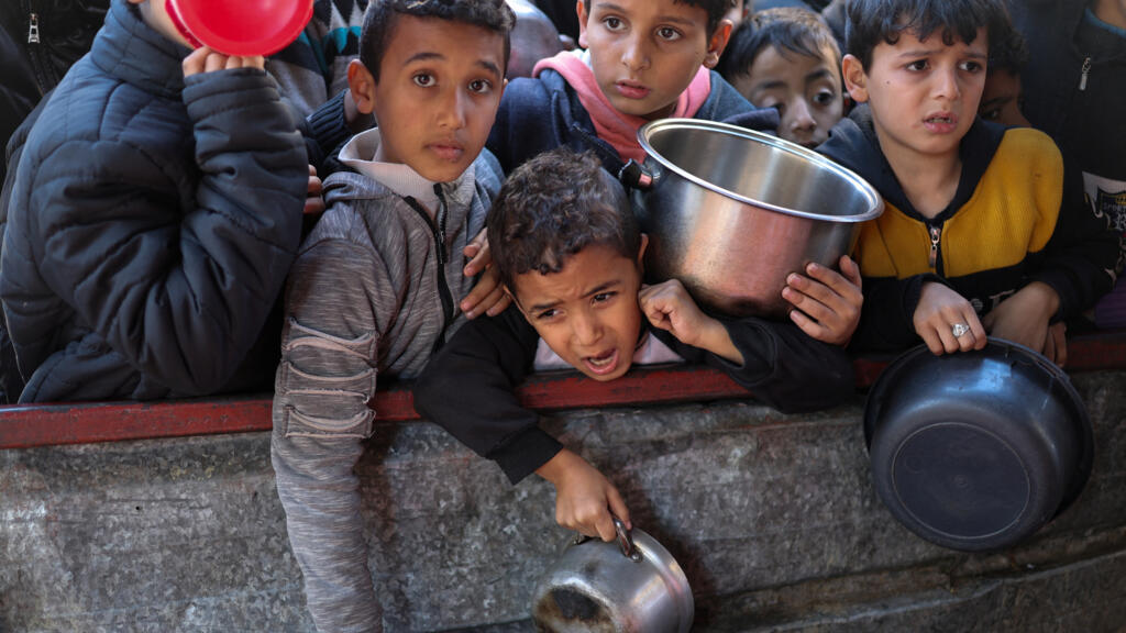 Des enfants palestiniens attendent de recevoir de la nourriture préparée par une cuisine caritative, le 5 février 2024.